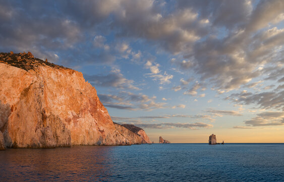 Sunset view of the spectacular walls rocciosedella south coast of uninhabited Poliegos close to Milos in the Greek Cyclades
