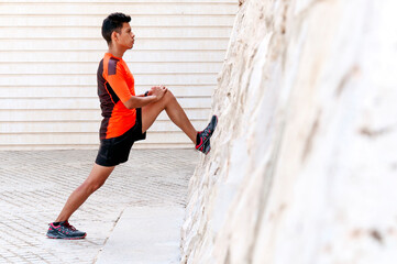 Latin boy doing stretching exercises