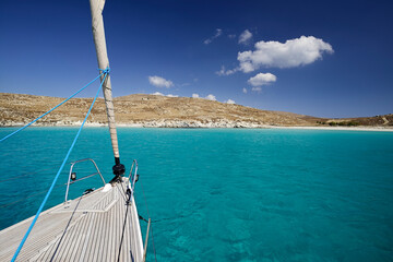 Blue water in the bay on the southwest coast of the Greek island of Rinia in the Cyclades
