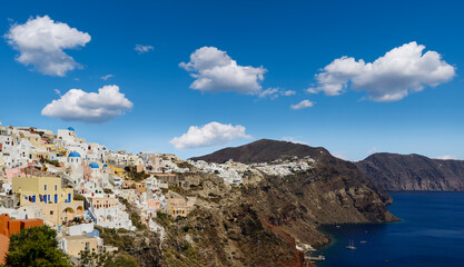 View of the village of Oia (La) and Finikia on the Greek island of Santorini in the Cyclades...