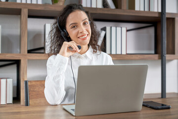 Customer support phone operator working at computer. Happy call center agent latin beautiful woman...