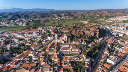 Fototapeta na wymiar The Portuguese historic village of Silves, Algarve zone, view from the sky, aerial. Fortress and church in the foreground. Portimao