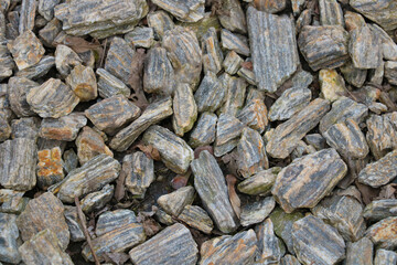 The texture of broken stones on the ground, background.