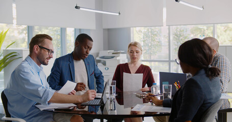 Group of young business people working together with laptop tablet and documents