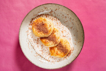 pancakes with maple syrup on pink background