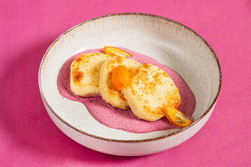 pancakes with maple syrup on pink background