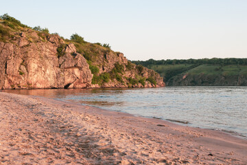 Beautiful landscape - river, rock, beach and sky in summer. Calm, a place for meditation without people.