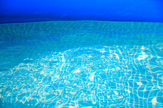 Outdoor inflatable pool with blue, clear water