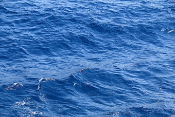 Small waves on sea surface. Beautiful blue color. Selective focus.