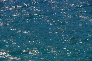 Small waves on sea surface. Beautiful blue color. Selective focus.