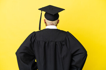 Young university graduate Colombian man isolated on yellow background in back position