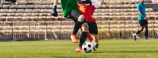 Two Football Players Running in Match. Soccer Tournament Game. Sideline Football Referee in the Background. Soccer Goalie in Dribbling Competition