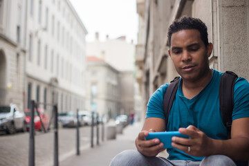 Latin tourist man in Europe with his smartphone