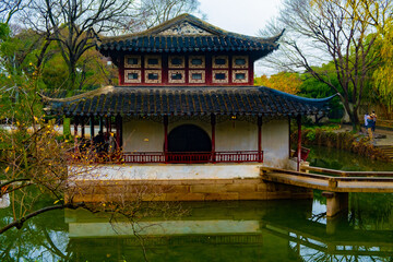 Naklejka premium Ancient pavilion chinese architecture building in Suzhou park with white and red walls, good place for trip
