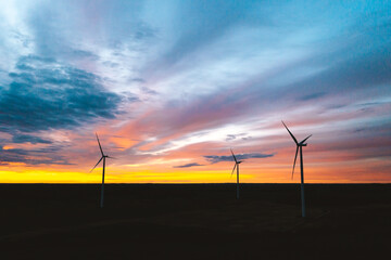 Fototapeta na wymiar Aerial view of wind farm turbines in a sunset sky in Lithuania.
