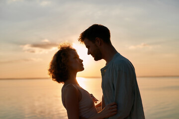 Portrait of sensual young man and woman at sunset