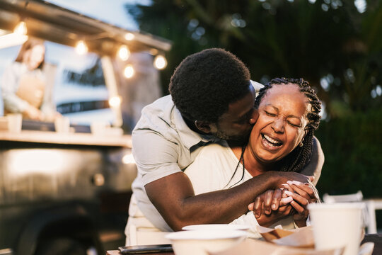 African Mother And Son Having Fun Together Outdoor At Food Truck Restaurant - Love And Family Lifestyle Concept - Focus On Mum Face