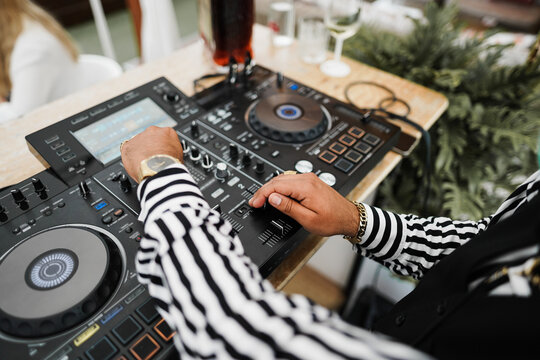 African Dj Playing Music At Cocktail Bar Outdoor - Focus On Right Hand