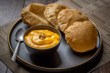 Aam Ras Puri or Alphonso Mango pulp with fried Poori