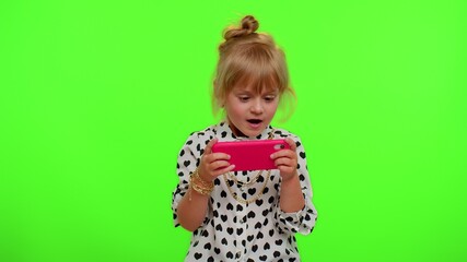 Worried funny addicted teen child girl enthusiastically playing racing video games on mobile phone. Young kid using smartphone gadget app with drive simulator isolayed on chroma key wall background