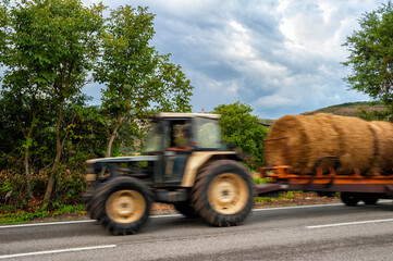 Blurred image of tractor on country road, 