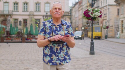 Elderly mature traveler guy grandfather pensioner getting lost in big city trying to find route....