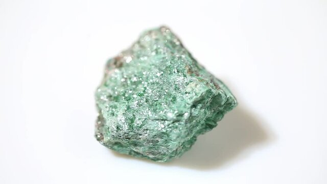 natural fuchsite rough gemstone on the background