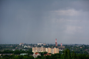 Fototapeta na wymiar City landscape. Gloomy rainy sky over the city
