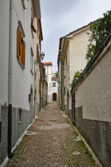 Fototapeta na wymiar A small street between the old houses of Agnone, a medieval village in the mountains of the Molise region, Italy.