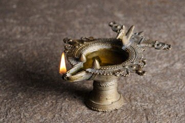 Indian traditional Samai or Samayee, a typical shape of diya (lamp) usually made up of brass, lit using cotton thread dipped in oil where we worship god at home or temple Holy Pooja.