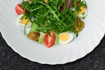 Delicious salad with medium beef, fresh vegetables, arugula and eggs