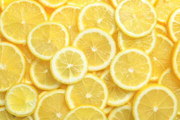 Many fresh juicy lemon slices as background, top view