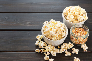 Popcorn and corn grains on a dark background