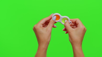 Hands holding silicone bubbles sensory toy simple dimple isolated on chroma key background. Playing push pop it popular educational children game. Trend 2021. Advertising, copy-space. Stress relief