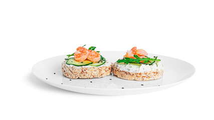 Bruschetta with cream cheese, shrimps cucumber and arugula leaves isolated on a white background....