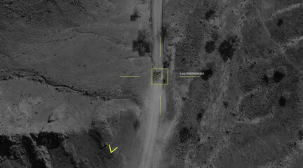 Aerial view of a military drone takes aim at a tank and shoots at it