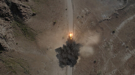 Aerial view of a military drone takes aim at a tank and shoots at it