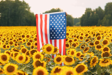 American flag in the sunflower field. 4th of July Independence Day USA concept
