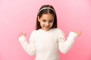 Little caucasian girl isolated on pink background with shocked facial expression