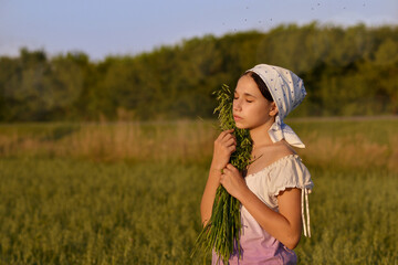 a girl in a field at sunset