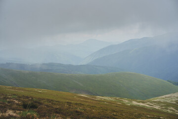 Naklejka premium Low clouds and fog over the mountains. Svidovets ridge. Ukraine, Carpathian mountains.