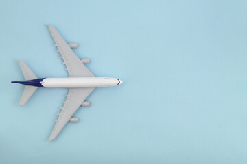 Airplane model on blue background., top view. Travel and transportation concept. Space for text.	