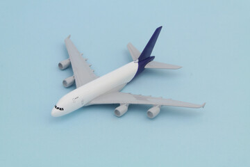 Airplane model on blue background. Travel concept.	