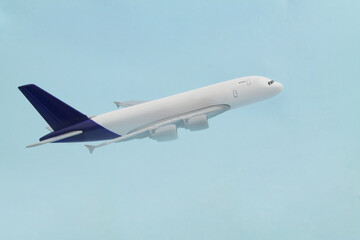 Fototapeta na wymiar Airplane model on blue background. Travel and transportation concept. 