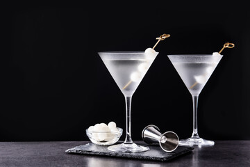 Gibson martini cocktail with onions on black background. Copy space