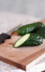 organic cucumbers and knife on the wooden desk