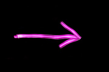 Long exposure light drawing arrow sign.