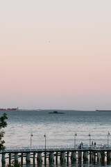 Obraz premium Submarine not far from wooden pier in the sea. Military exercise