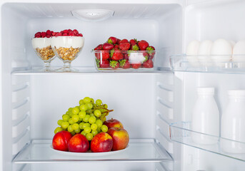 Open fridge full of fresh fruits and vegetables