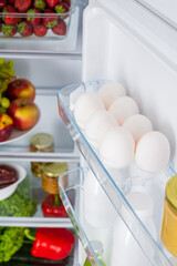 Open fridge full of fresh fruits and vegetables